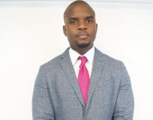 A man in a suit and tie standing up.